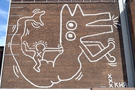 Keith Haring, muurschildering, 1986. Food Center in Amsterdam-West.